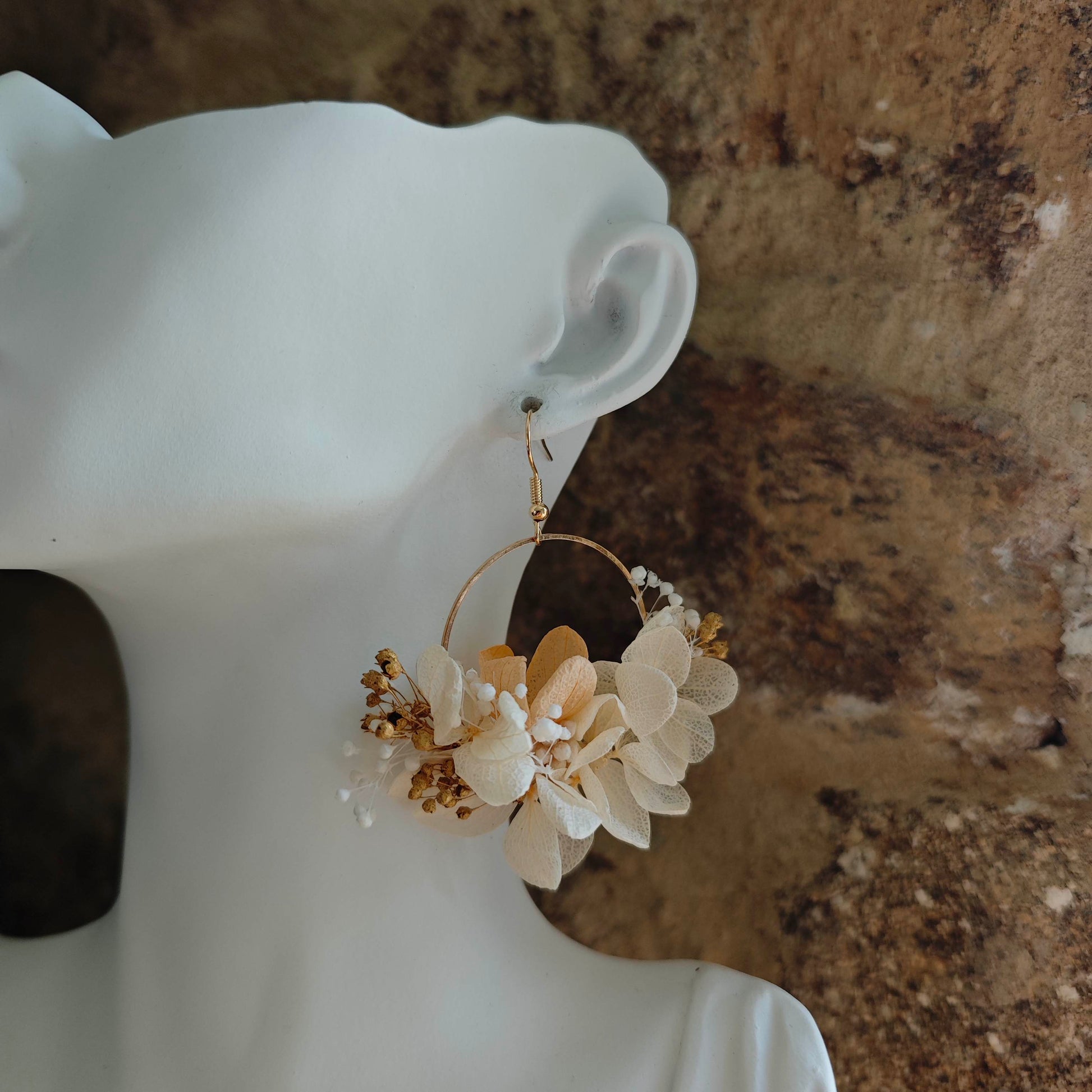 Détail des fleurs séchées ivoire et gypsophile sur anneau doré