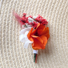 Charger l&#39;image dans la galerie, Broche florale Léna épinglée sur un chapeau en paille, avec des fleurs stabilisées orange, blanc et rouge.
