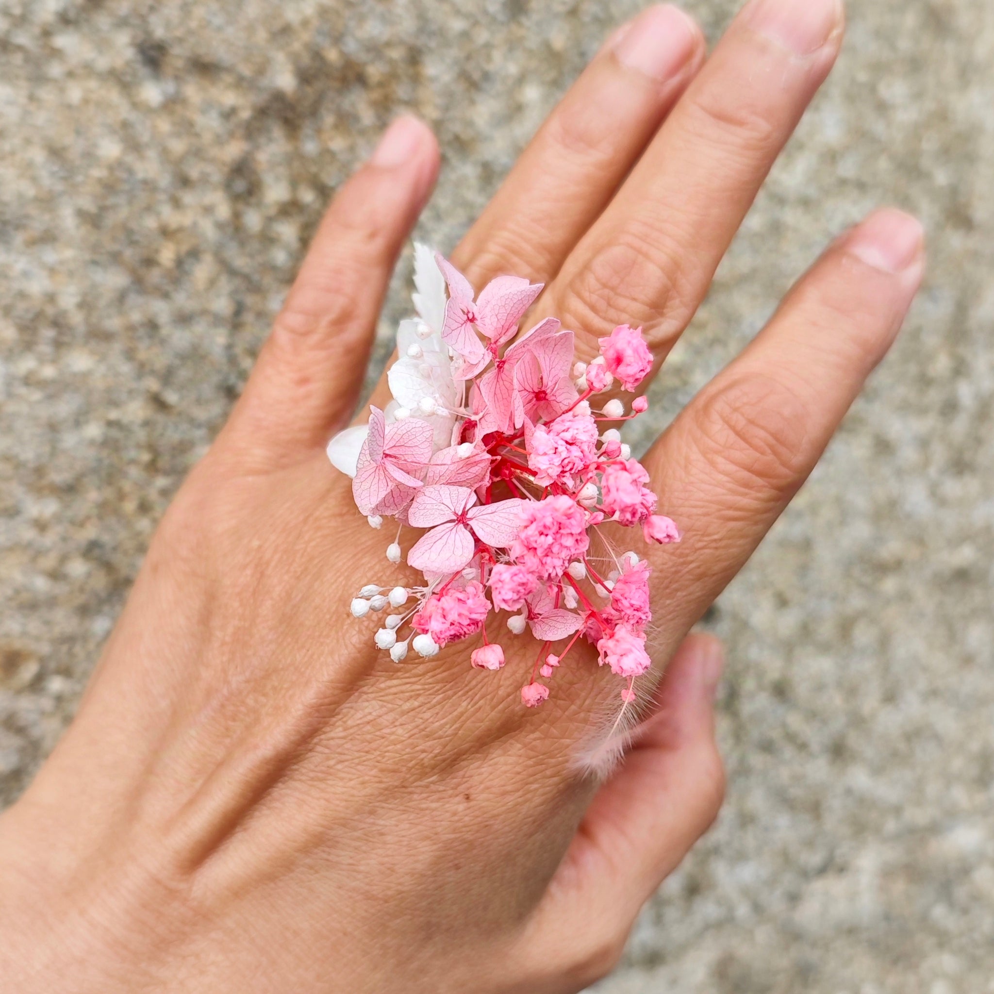 Vidéo montrant la bague en fleurs séchées de la collection Lilas sous différents angles, mettant en valeur les détails des fleurs roses et blanches et la finition artisanale
